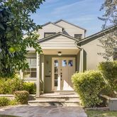 front view of a house with a tree
