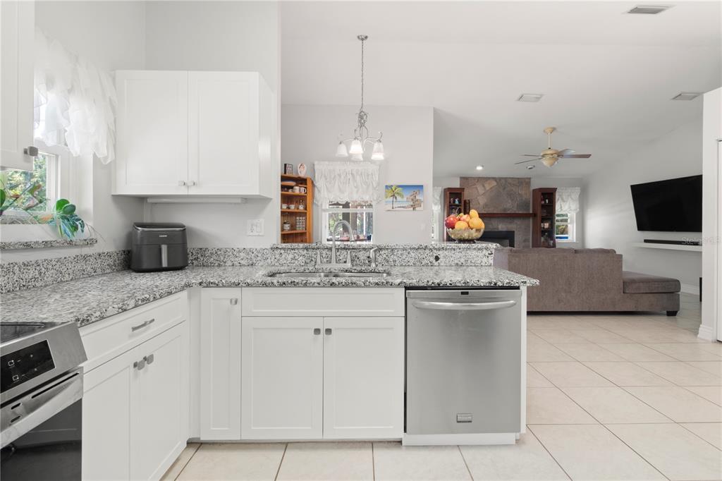 5910 Bella Road Parrish, FL 34219 - Photo 11 of 57 a kitchen with stainless steel appliances granite countertop a sink and a stove