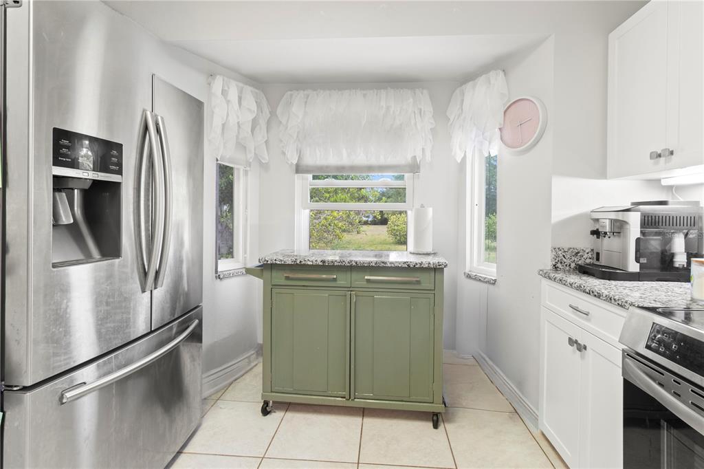 5910 Bella Road Parrish, FL 34219 - Photo 12 of 57 a kitchen with stainless steel appliances granite countertop a refrigerator and a sink
