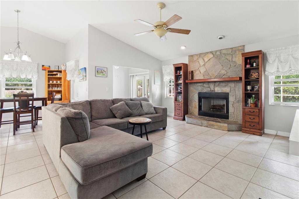 5910 Bella Road Parrish, FL 34219 - Photo 16 of 57 a living room with furniture and a fireplace