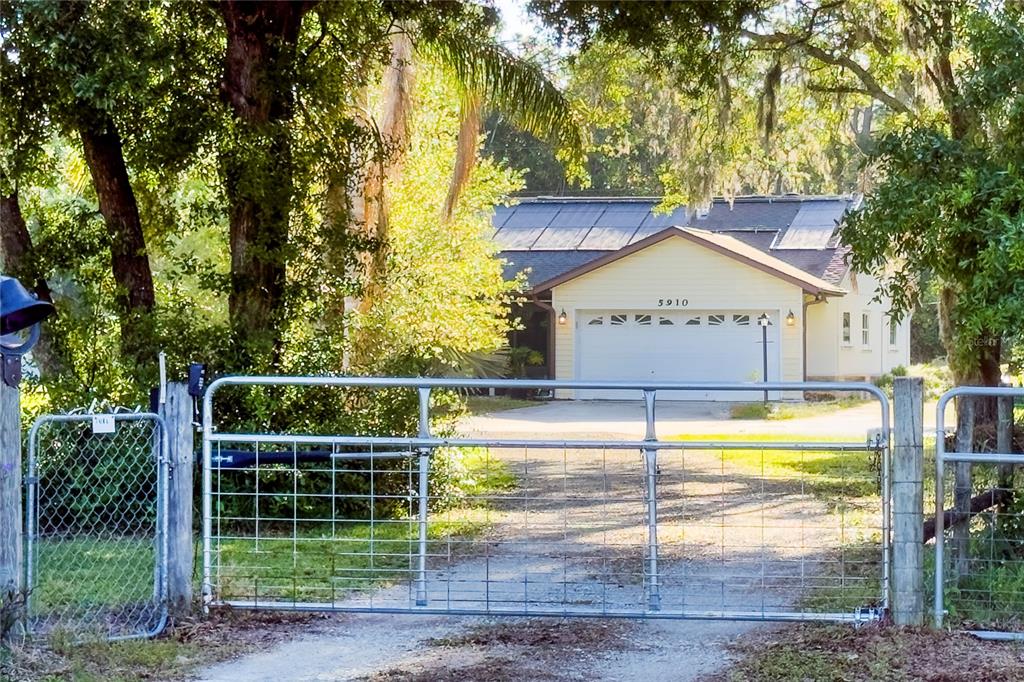 5910 Bella Road Parrish, FL 34219 - Photo 2 of 57 a view of a house with a backyard and a tree