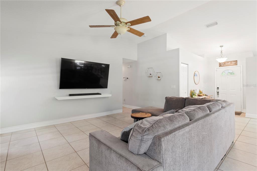 5910 Bella Road Parrish, FL 34219 - Photo 23 of 57 a living room with furniture and a flat screen tv