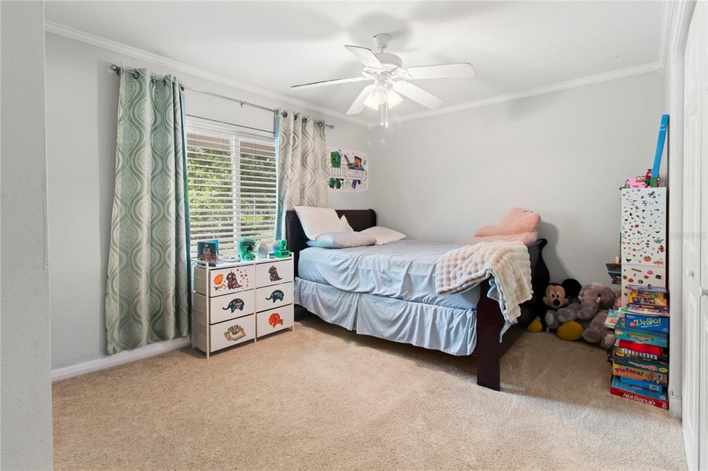5910 Bella Road Parrish, FL 34219 - Photo 25 of 57 a bedroom with a bed and a chandelier