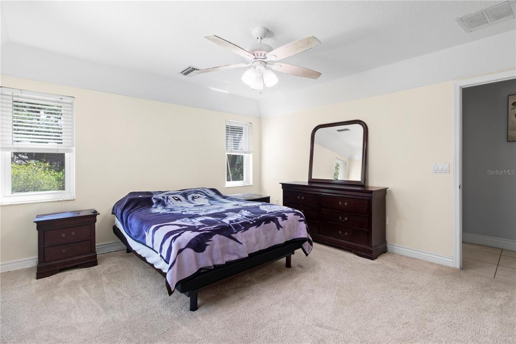 5910 Bella Road Parrish, FL 34219 - Photo 30 of 57 a bedroom with a bed and a dresser with the potted plant