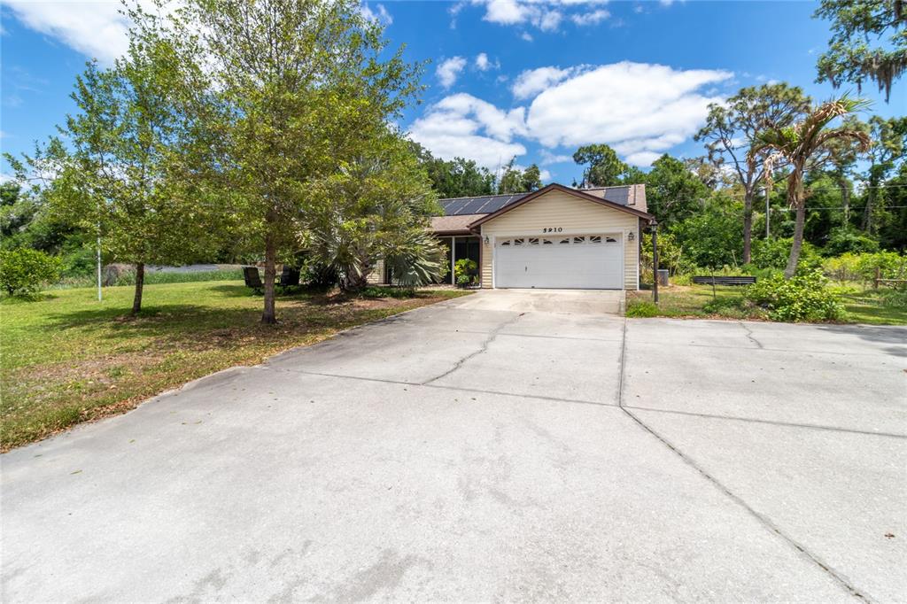 5910 Bella Road Parrish, FL 34219 - Photo 3 of 57 a front view of a house with a yard and garage