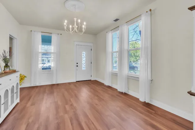a view of a dining room with furniture window and wooden floor