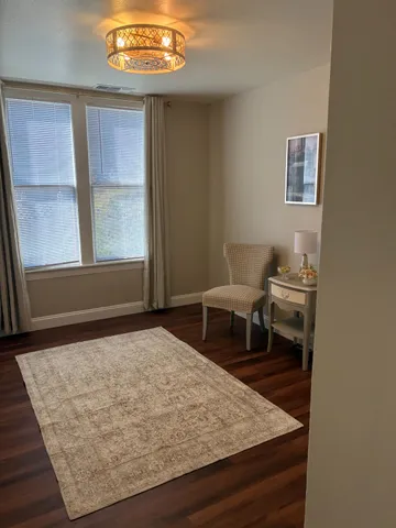 a view of a hallway with wooden floor and entryway