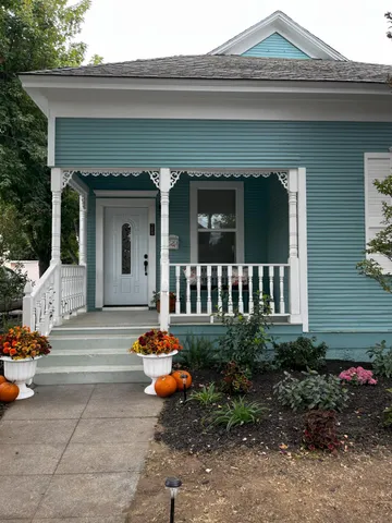 front view of a house with potted plants