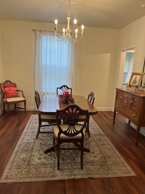 1659 Hazel Street Gridley, CA 95948 - Photo 64 of 70 a dining room with wooden floor a chandelier a wooden table and chairs