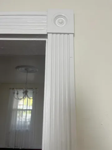 a room with a table chairs and entryway