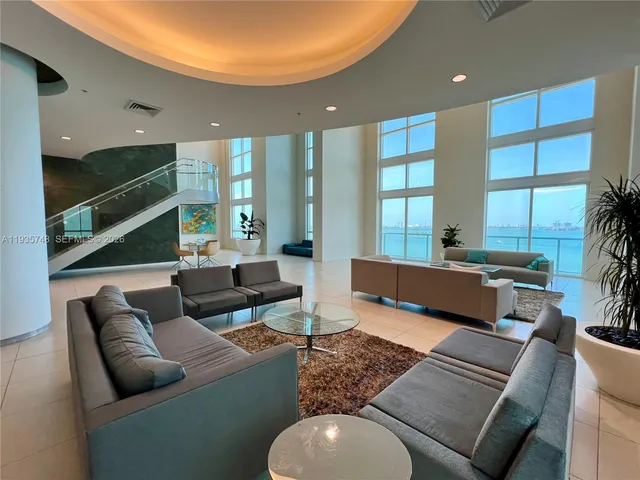 a living room with furniture and kitchen view