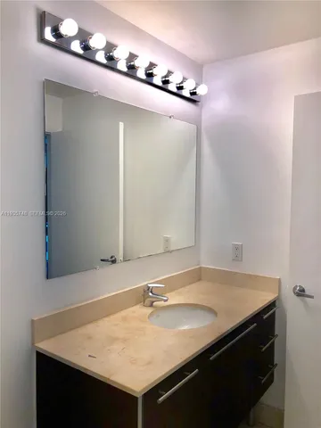 a view of a room with wooden floor and windows