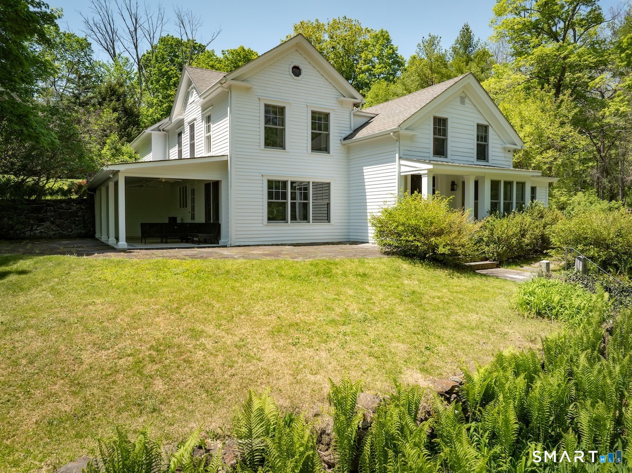 329 Housatonic River Road Salisbury, CT 06031 - Photo 2 of 32 a front view of house with yard and trees around