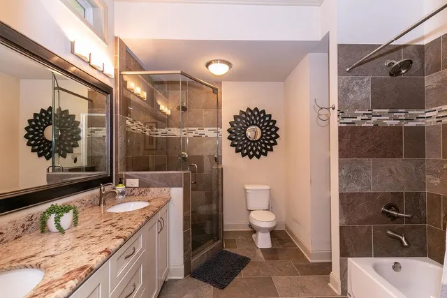 a kitchen with stainless steel appliances granite countertop a sink a refrigerator a stove a center island and chairs