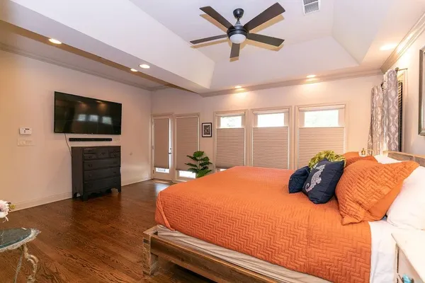 a bedroom with a bed and wooden floor