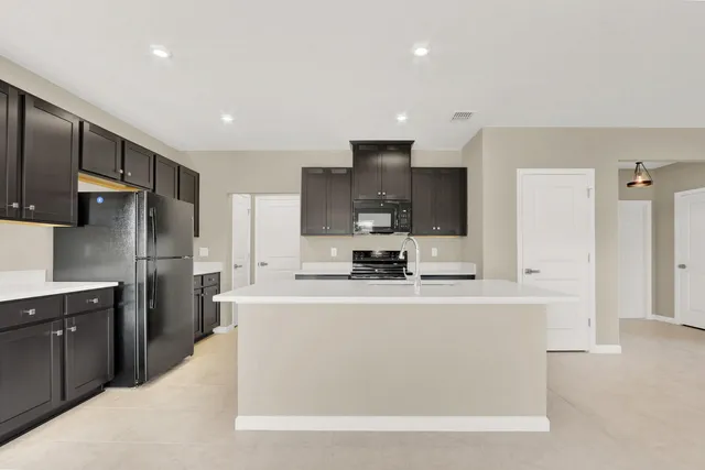 a kitchen with stainless steel appliances a sink stove and refrigerator
