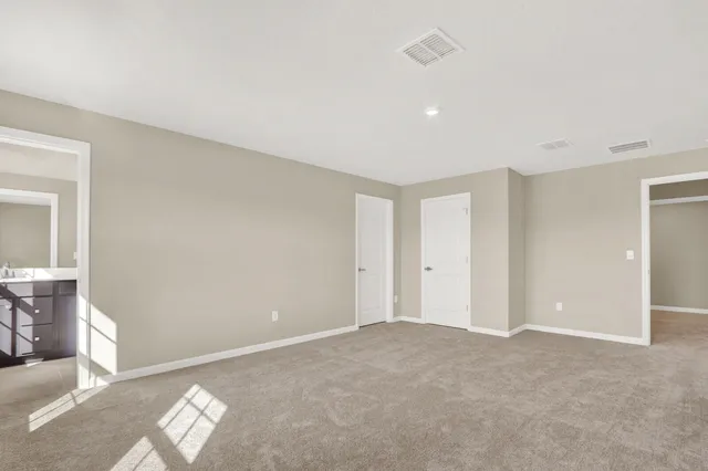 a bathroom with a toilet a sink a mirror and a shower