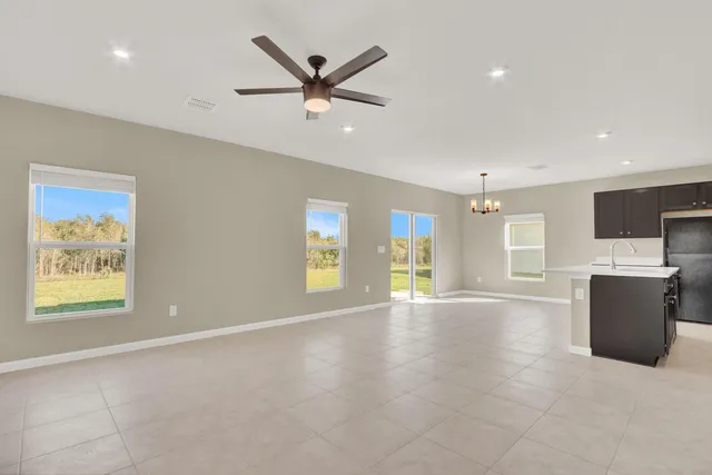 an empty room with window and couch