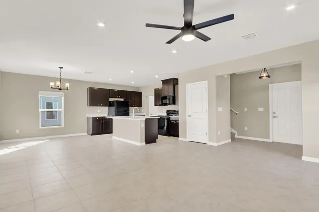 a view of kitchen with stainless steel appliances refrigerator oven and open kitchen
