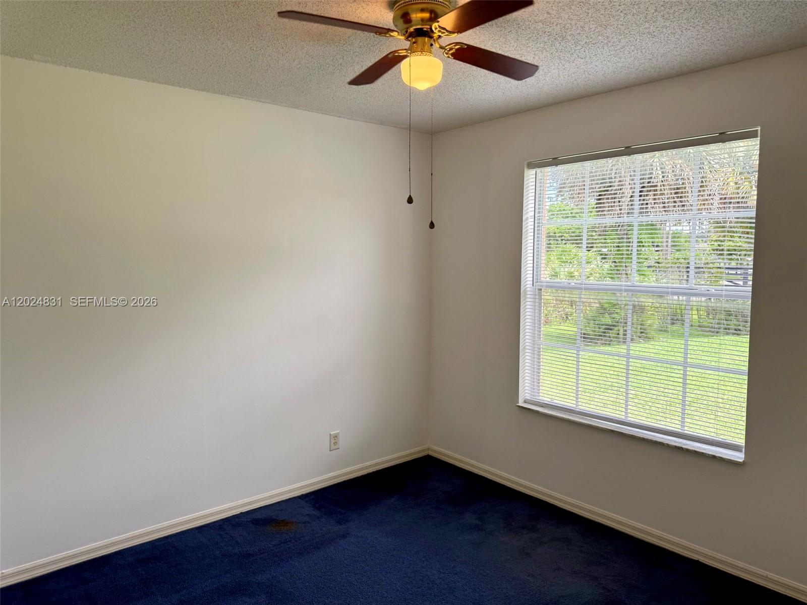 15819 76th Road North Loxahatchee, FL 33470 - Photo 42 of 45 a view of an empty room with wooden floor and a window