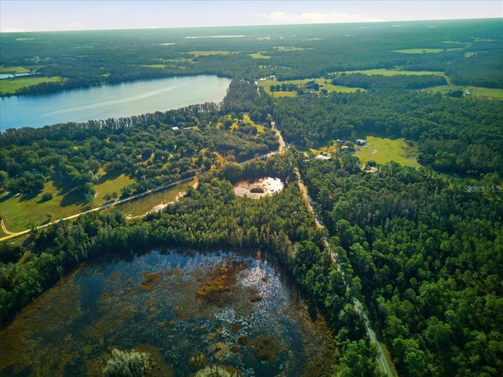 Lake Erie Road Groveland, FL 34736 - Photo 7 of 8 a view of a lake with a yard and large trees