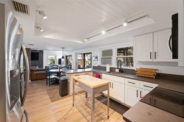 a bathroom with a granite countertop sink toilet a mirror a vanity and shower