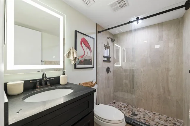 a bedroom with a bed couch and window