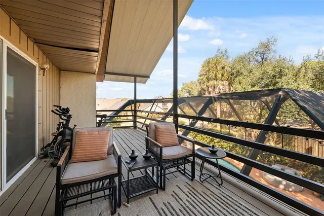 a bedroom with furniture and large windows