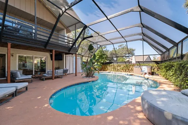 an aerial view of residential house with outdoor space and trees