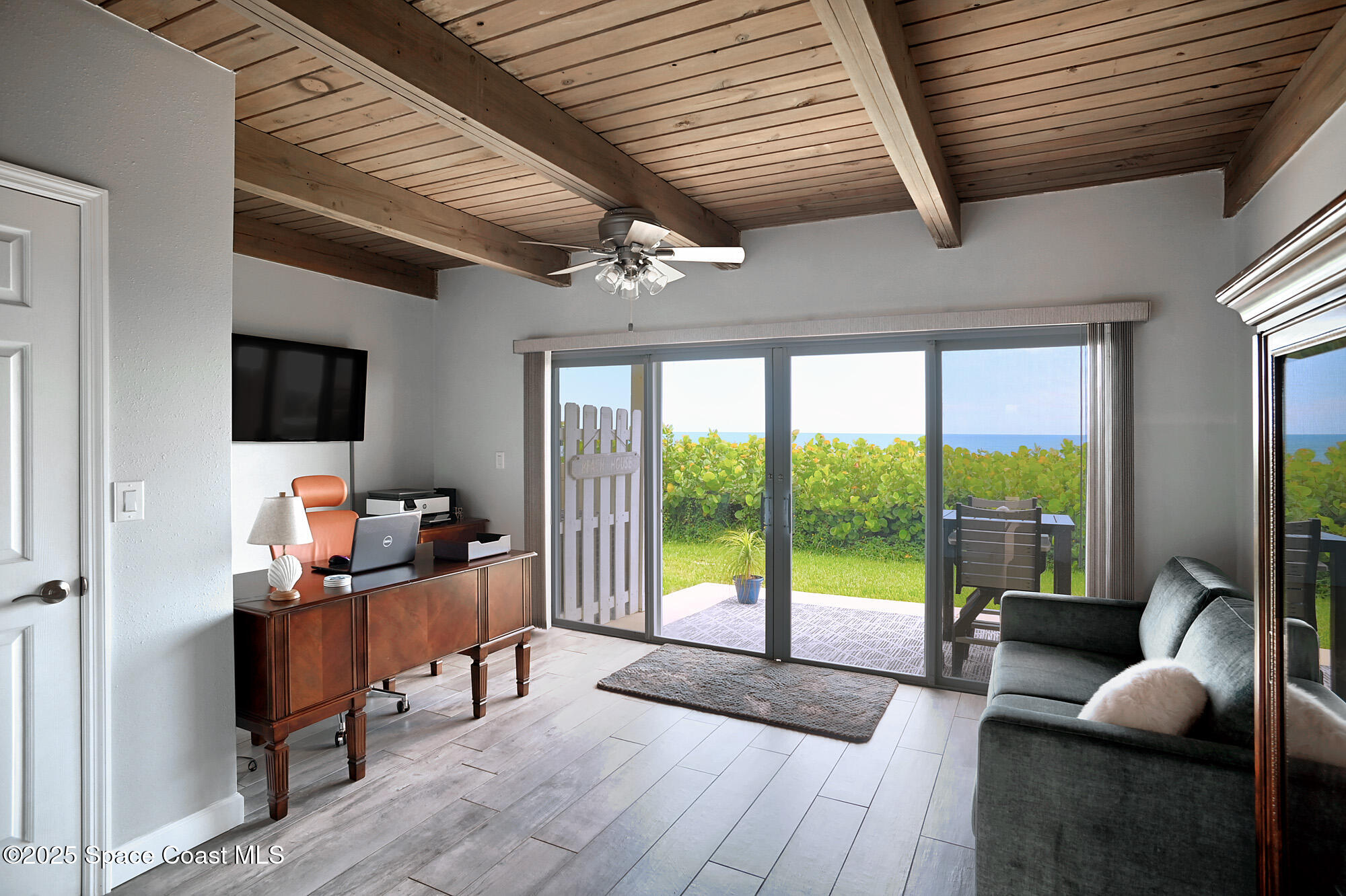 2953 South Hwy A1A, Unit 7B Melbourne Beach, FL 32951 - Photo 15 of 22 a work room with wooden floor and furniture