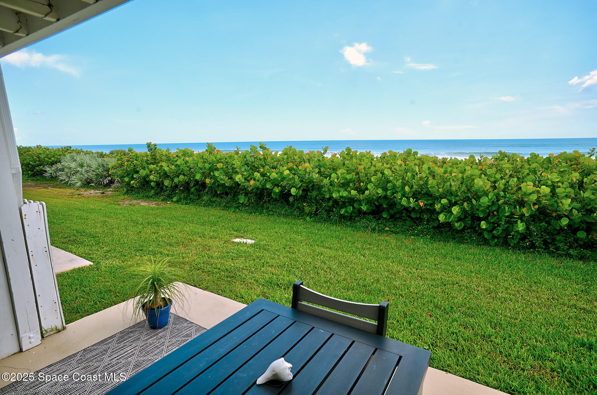 2953 South Hwy A1A, Unit 7B Melbourne Beach, FL 32951 - Photo 17 of 22 a view of a deck with a yard
