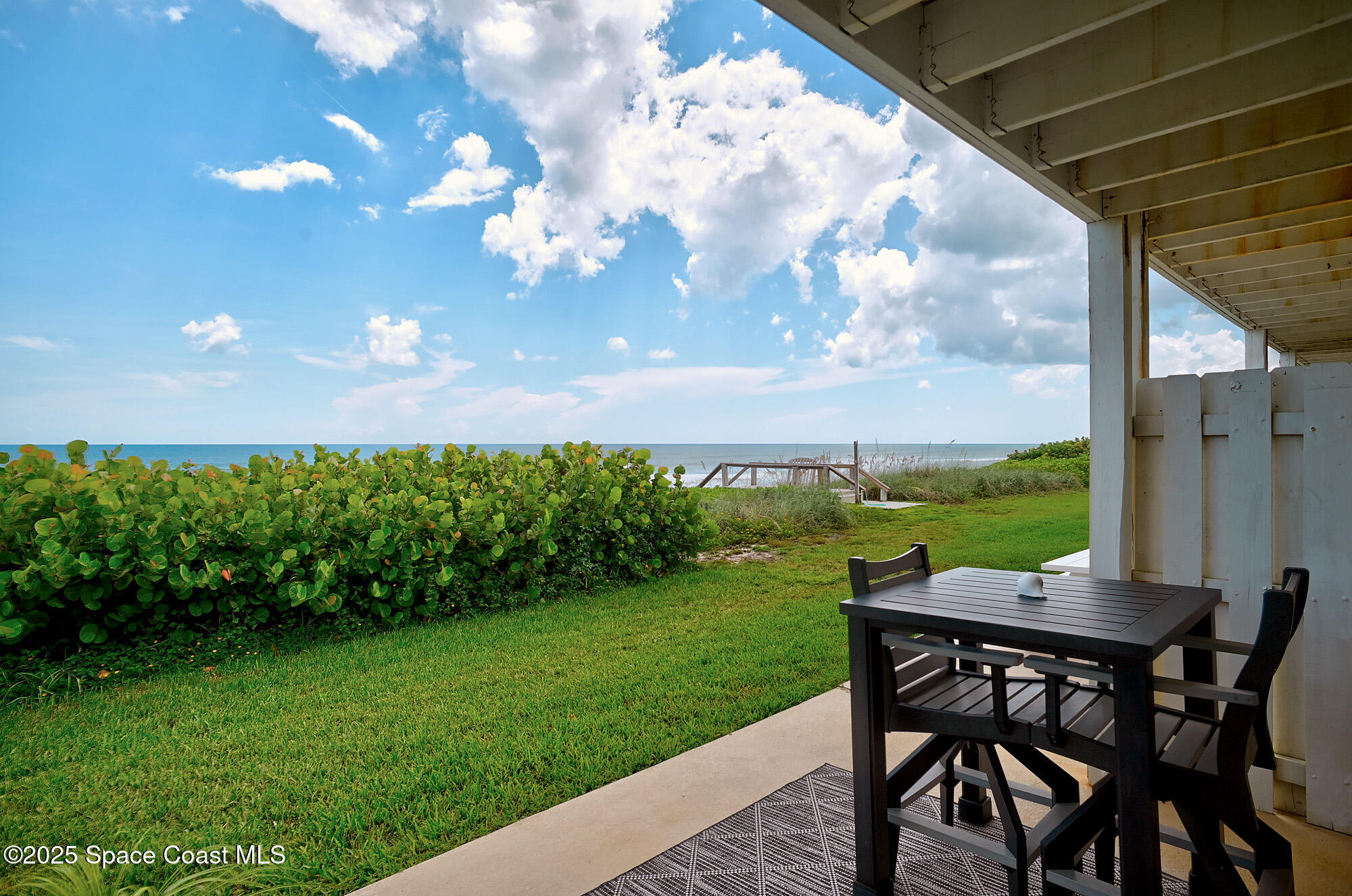 2953 South Hwy A1A, Unit 7B Melbourne Beach, FL 32951 - Photo 18 of 22 a view of yard with seating area and green space