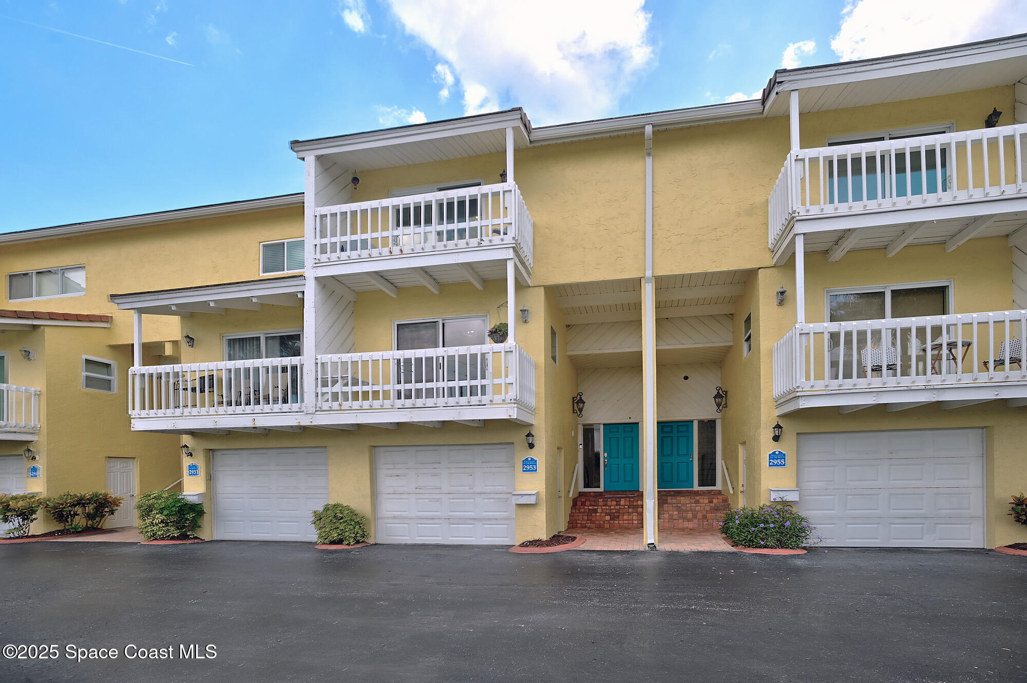 2953 South Hwy A1A, Unit 7B Melbourne Beach, FL 32951 - Photo 19 of 22 a front view of a building with glass windows and a table