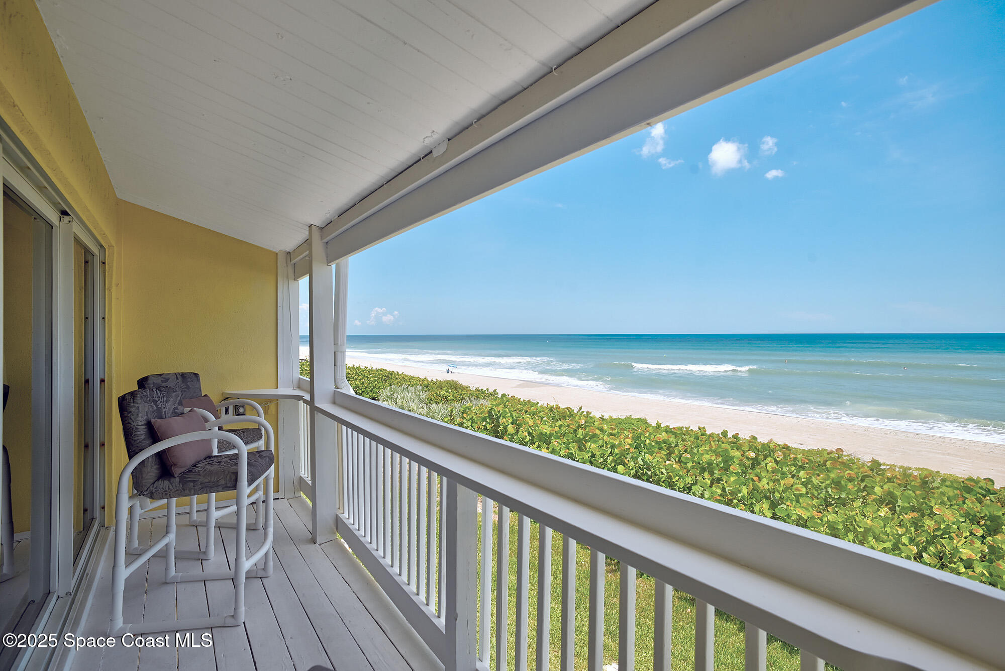 2953 South Hwy A1A, Unit 7B Melbourne Beach, FL 32951 - Photo 5 of 22 a view of a balcony with chair and table & chairs