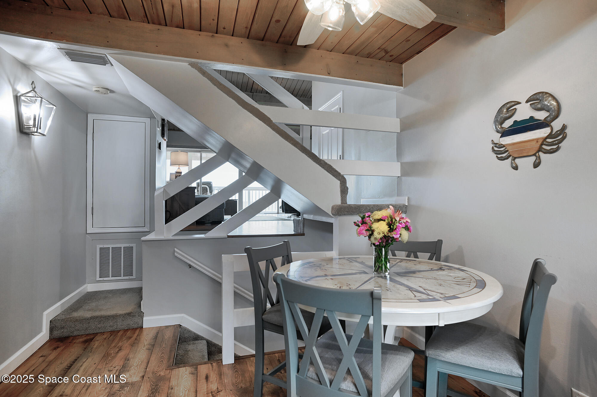 2953 South Hwy A1A, Unit 7B Melbourne Beach, FL 32951 - Photo 10 of 22 a view of a dining room with furniture and wooden floor