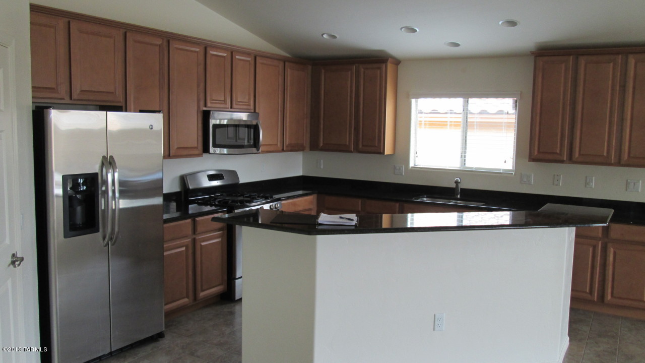 10855 East New Rock Ridge Drive Vail, AZ 85641 - Photo 8 of 34 a kitchen with a sink and cabinets