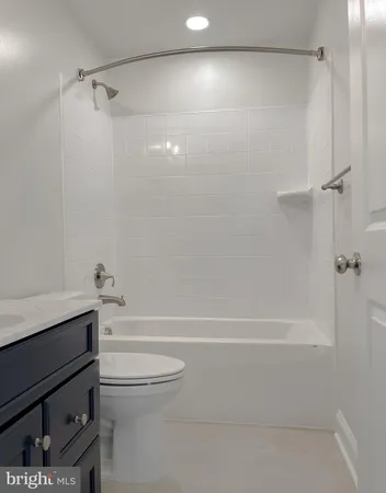 a bathroom with a shower a toilet and a sink