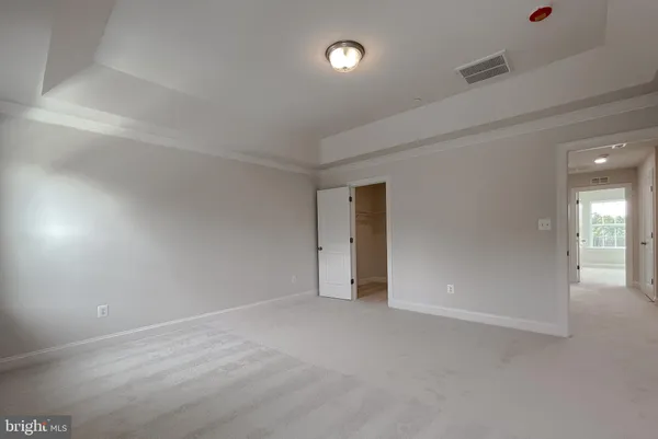 an empty room with entrance and windows