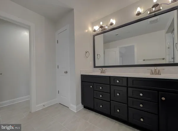 a bathroom with a sink vanity and a mirror