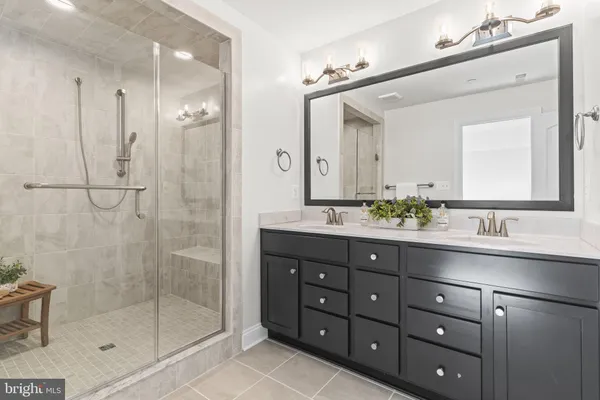 a bathroom with a shower sink and mirror