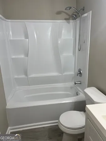 a bathroom with a toilet and bathtub