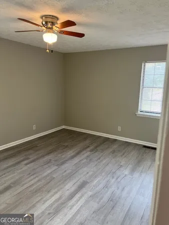 a view of a room with wooden floor and windows