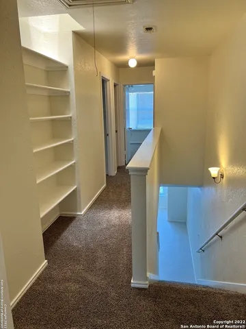 an empty room with a ceiling fan and a window