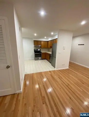 a view of a kitchen with wooden floor