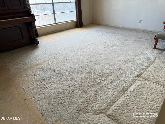 a view of a livingroom with an empty space and a fireplace