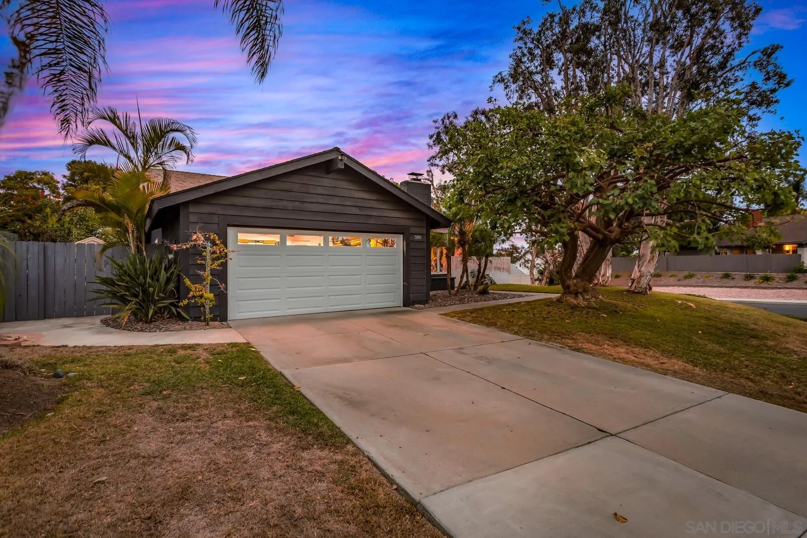 398 Compass Road Oceanside, CA 92054 - Photo 2 of 42 a front view of a house with a yard and garage