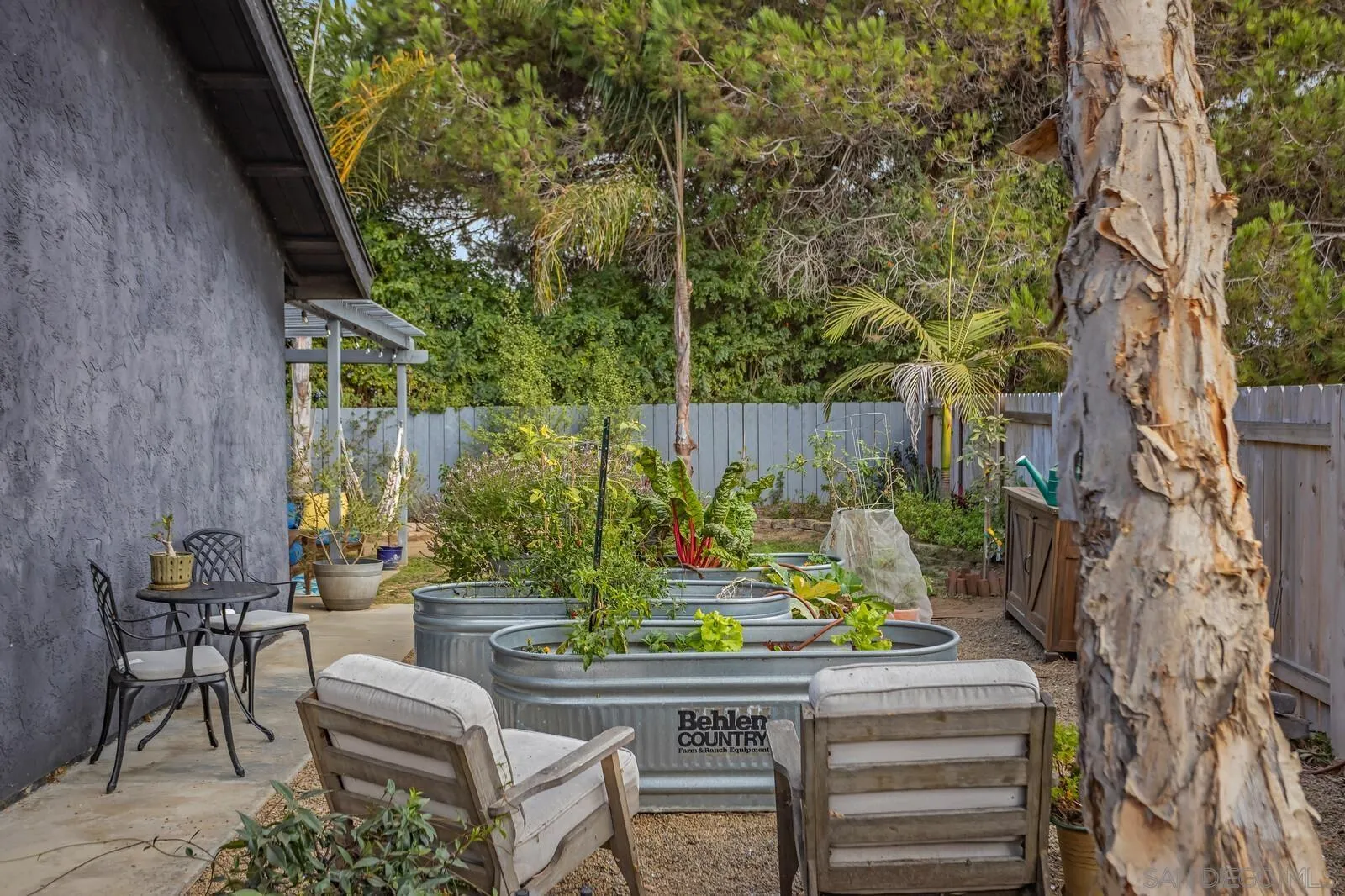 398 Compass Road Oceanside, CA 92054 - Photo 25 of 42 a patio with couches table and chairs and potted plants