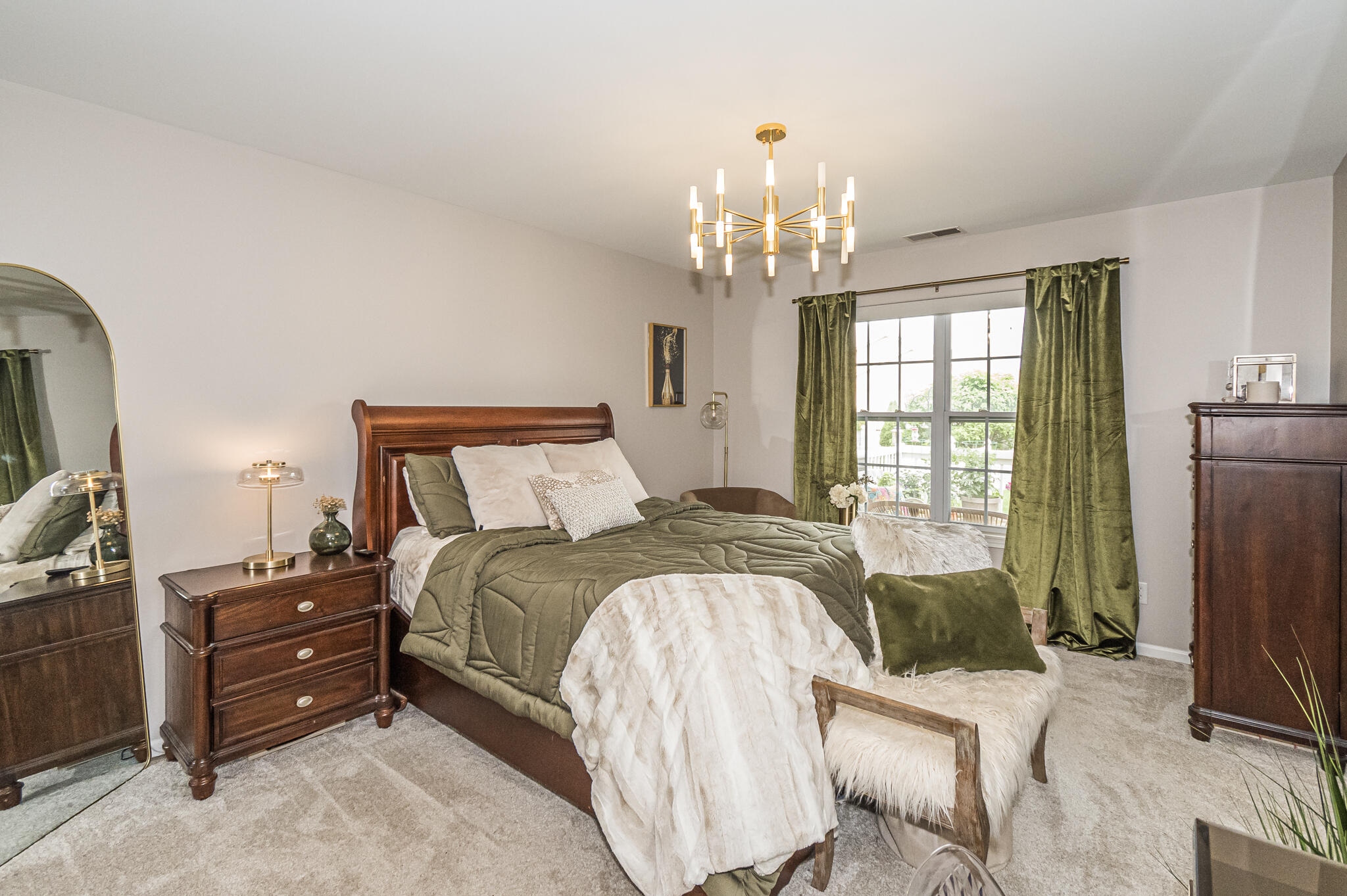 10735 Keystone Lane Crown Point, IN 46307 - Photo 13 of 23 a spacious bedroom with a bed and a chandelier
