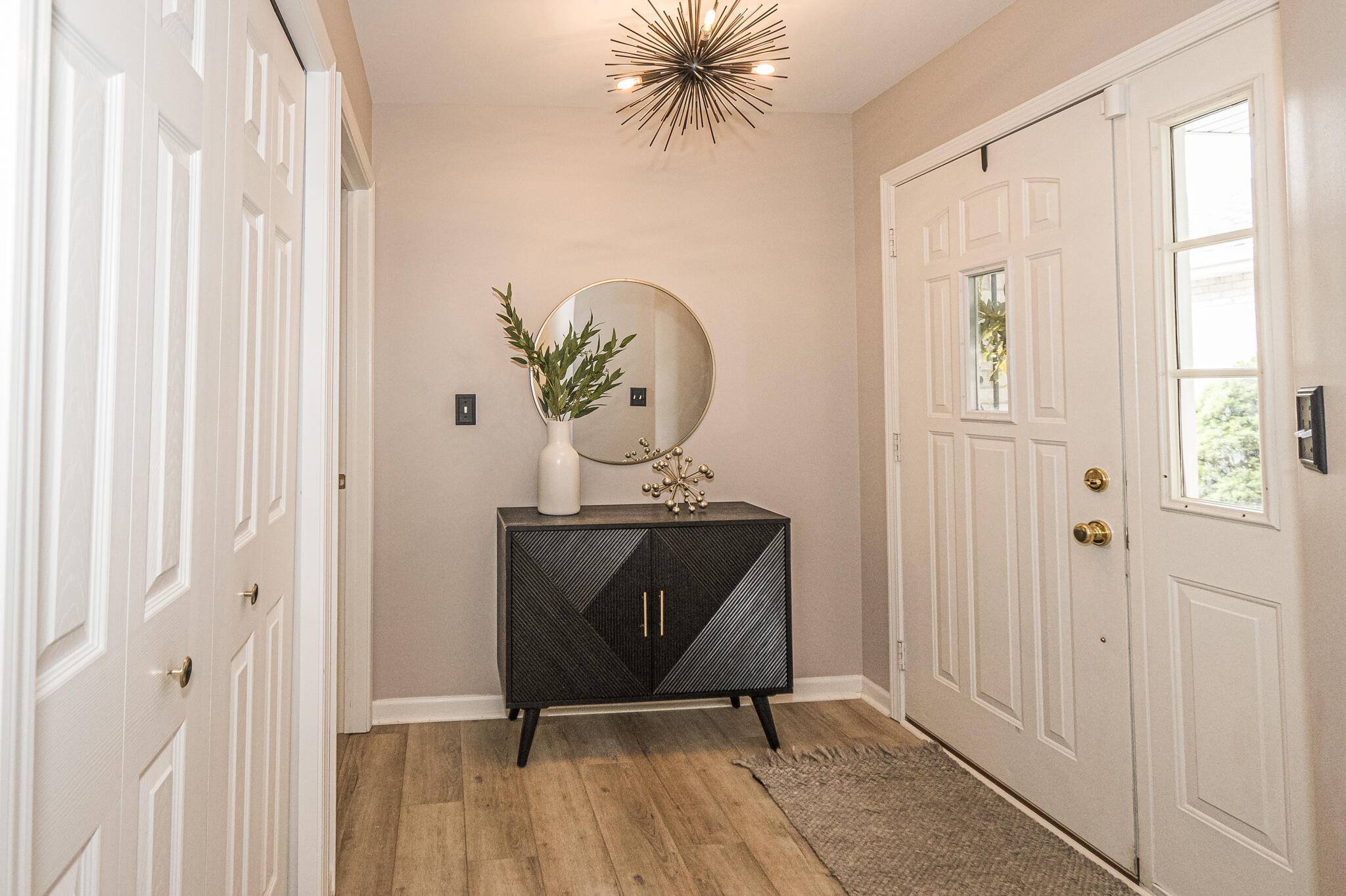 10735 Keystone Lane Crown Point, IN 46307 - Photo 4 of 23 a view of a hallway with wooden floor and windows