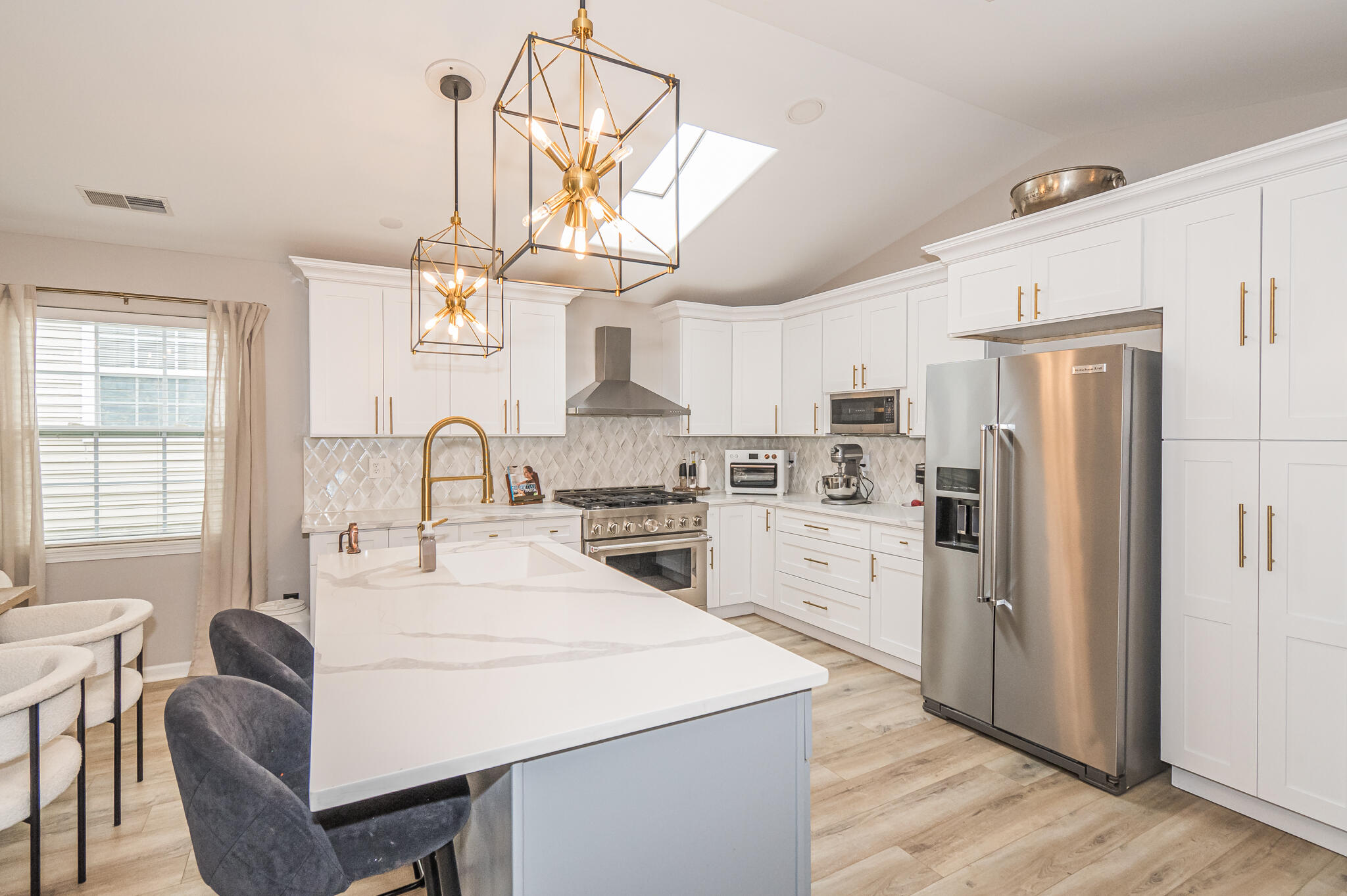 10735 Keystone Lane Crown Point, IN 46307 - Photo 6 of 23 a kitchen with stainless steel appliances a table chairs and chandelier
